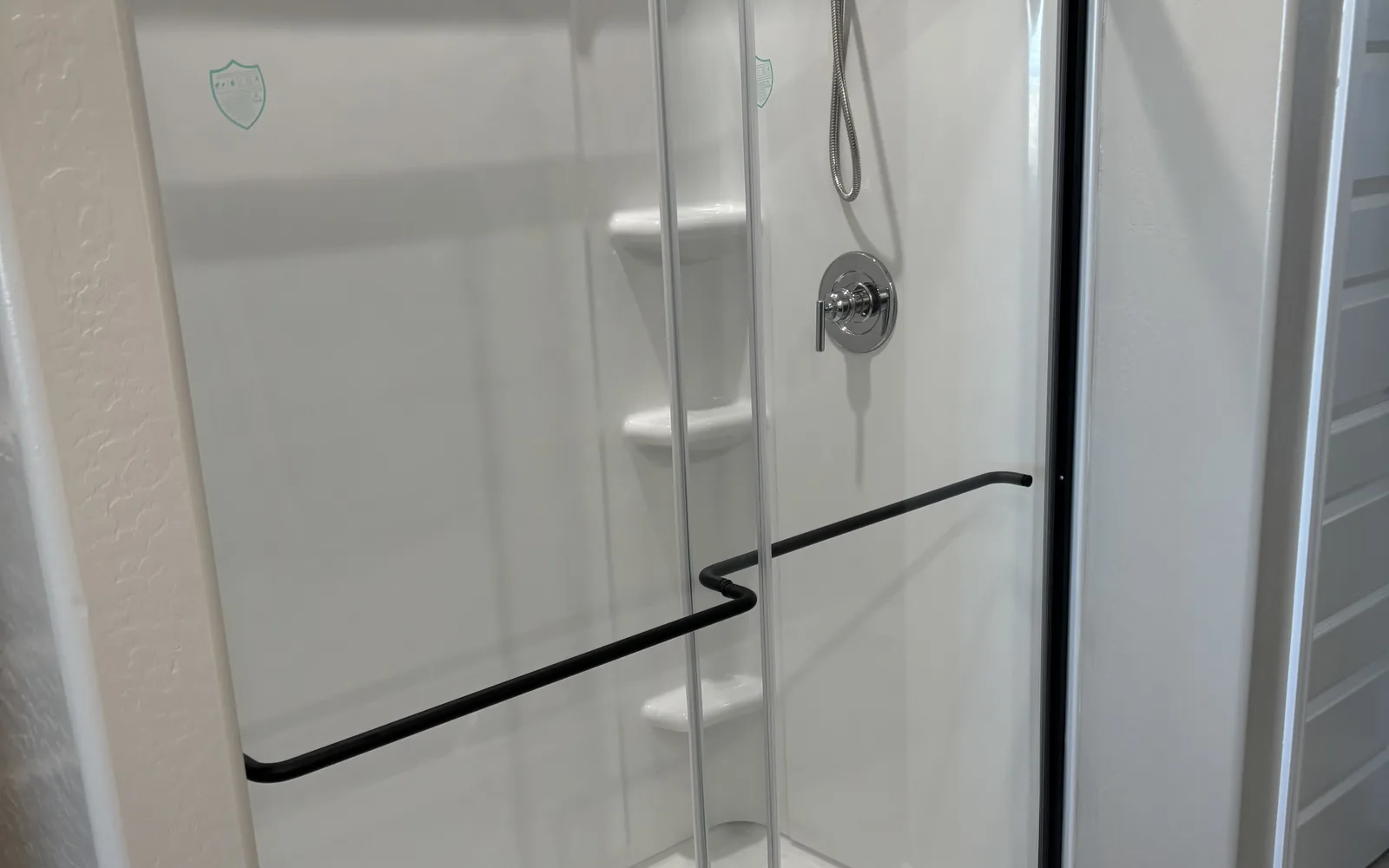 New shower surround with a framed sliding glass door and a single-handle valve
