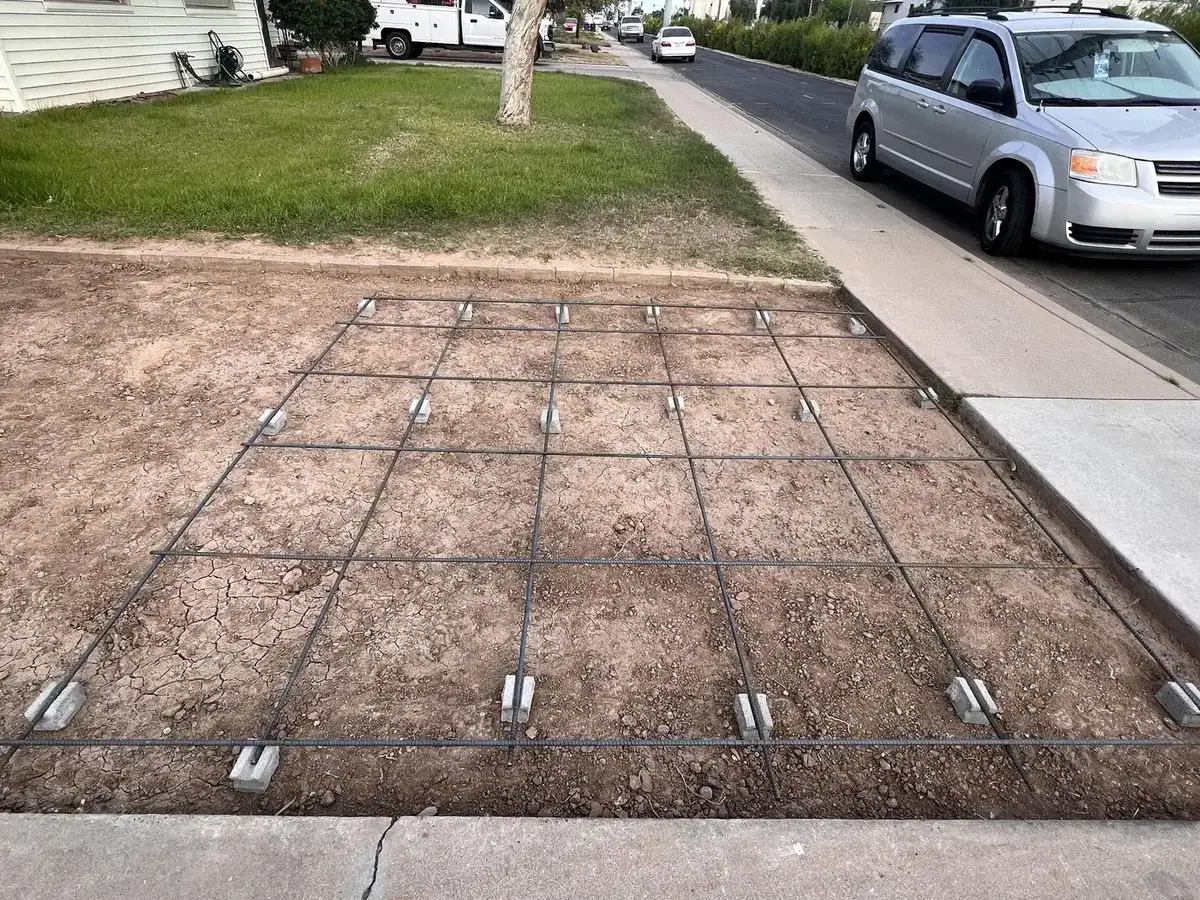 Rebar grid laid over prepared ground for a concrete driveway pour